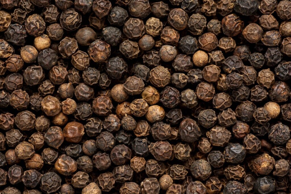 large pile of black peppercorns