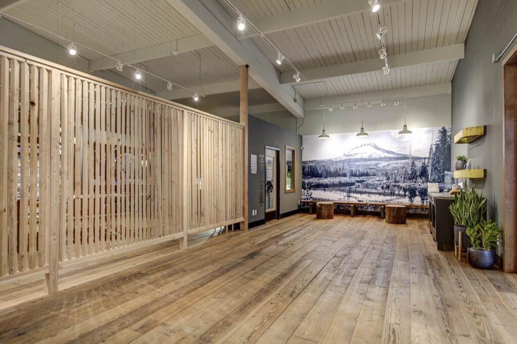 dispensary interior with wood floor and light colored wood dividerr 
