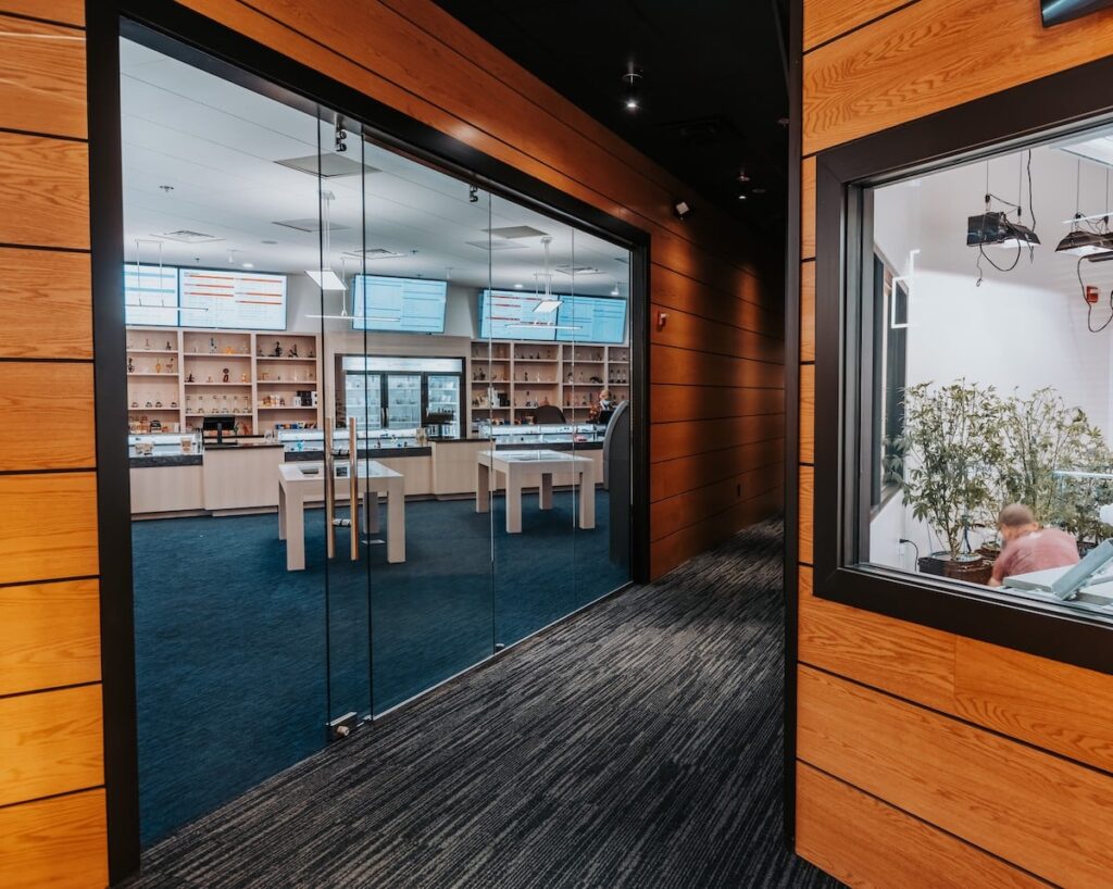 business entrance with glass doors blue carpet wood walls 