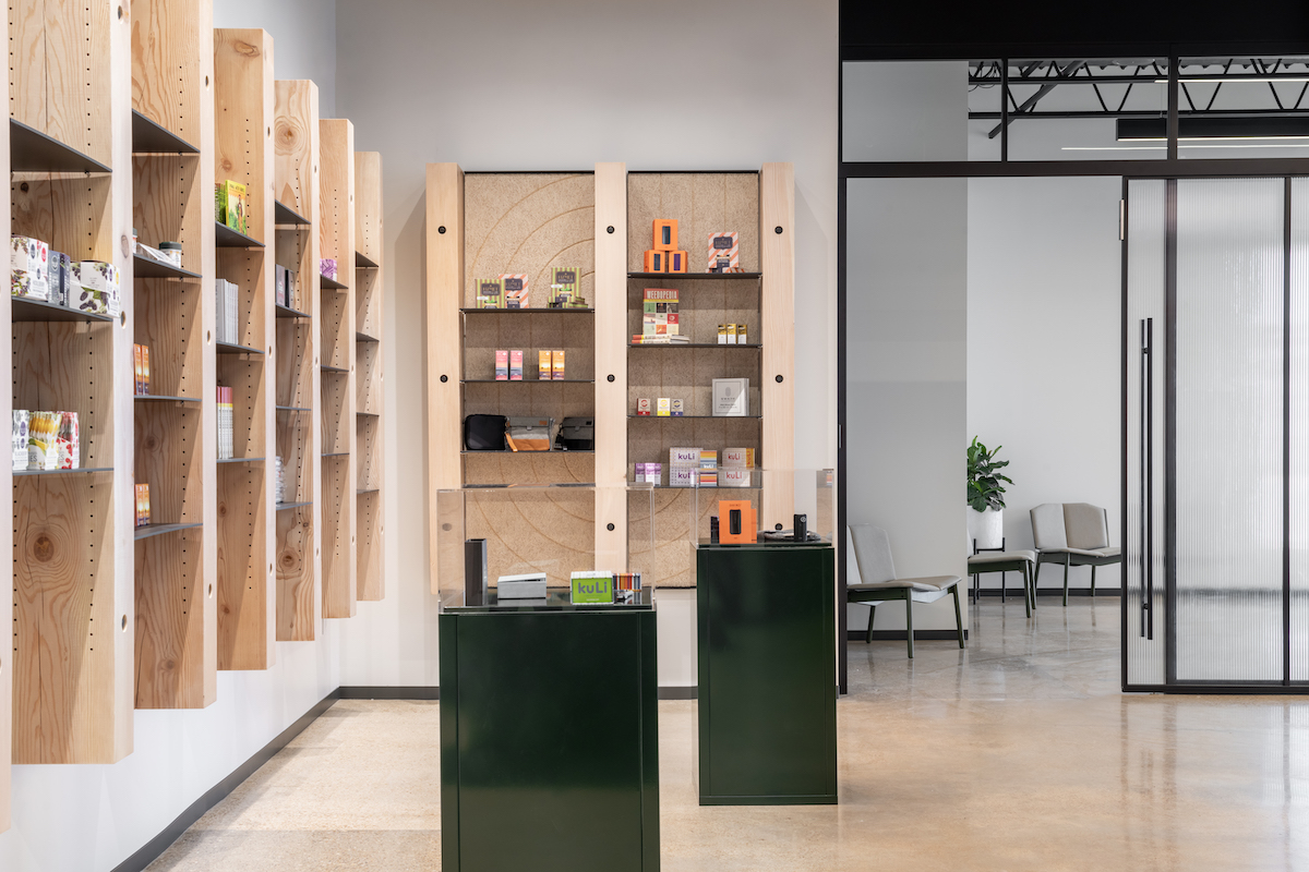 dispensary interior with wood floors and wood shelving on the walls
