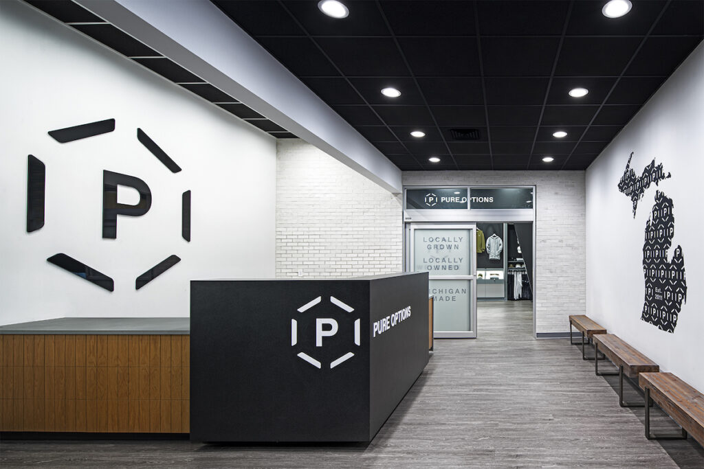 pure options dispensary entrance white walls black counter big P printed on the wall 
