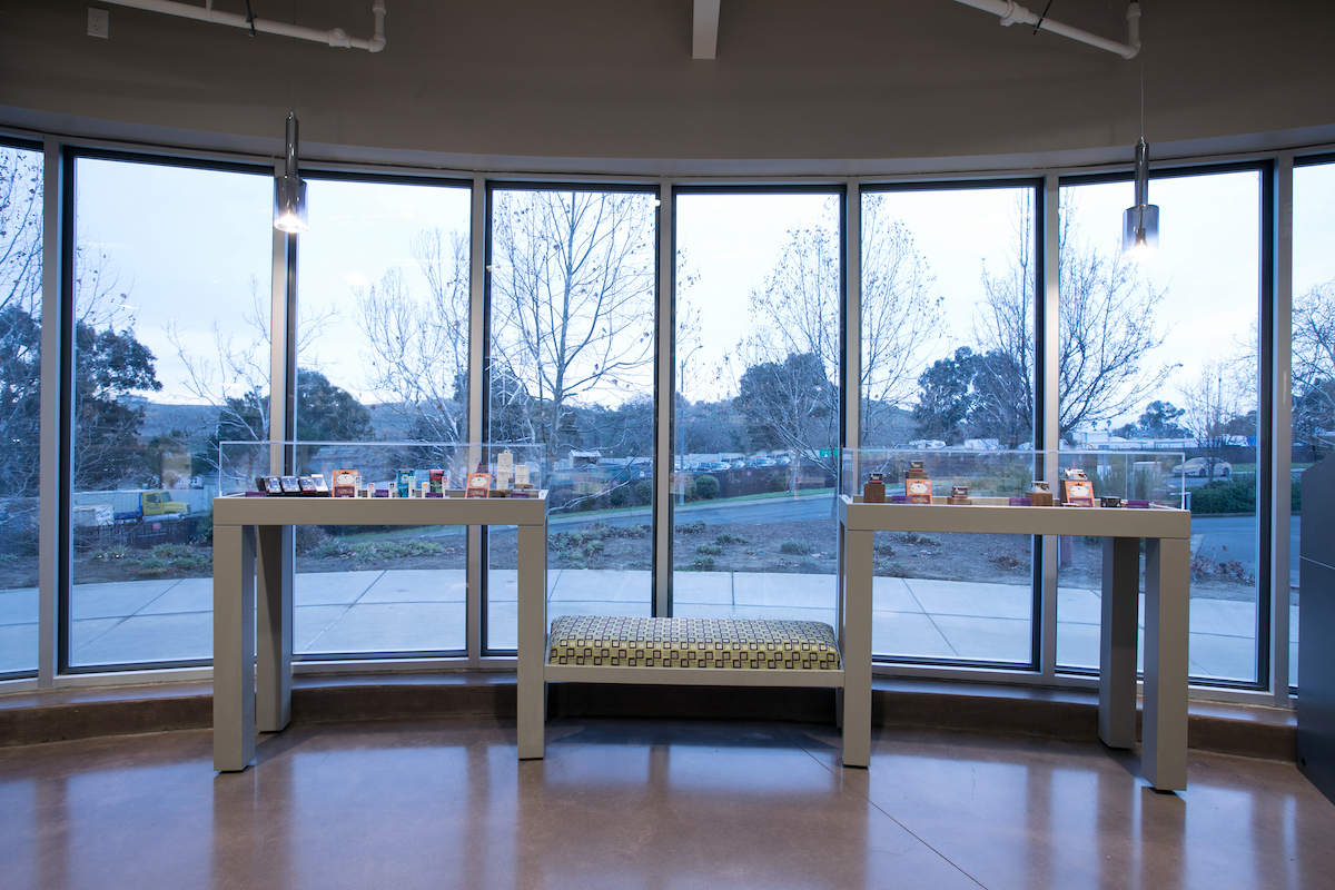 large floor to ceiling window wall with two display tables positioned symmetrically in front of the windows