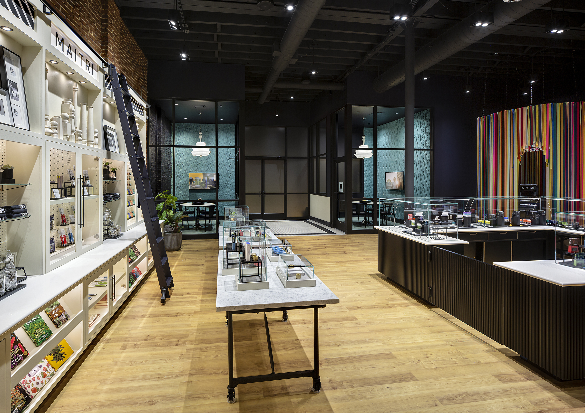 dispensary interior with wood floor and black walls and display cases