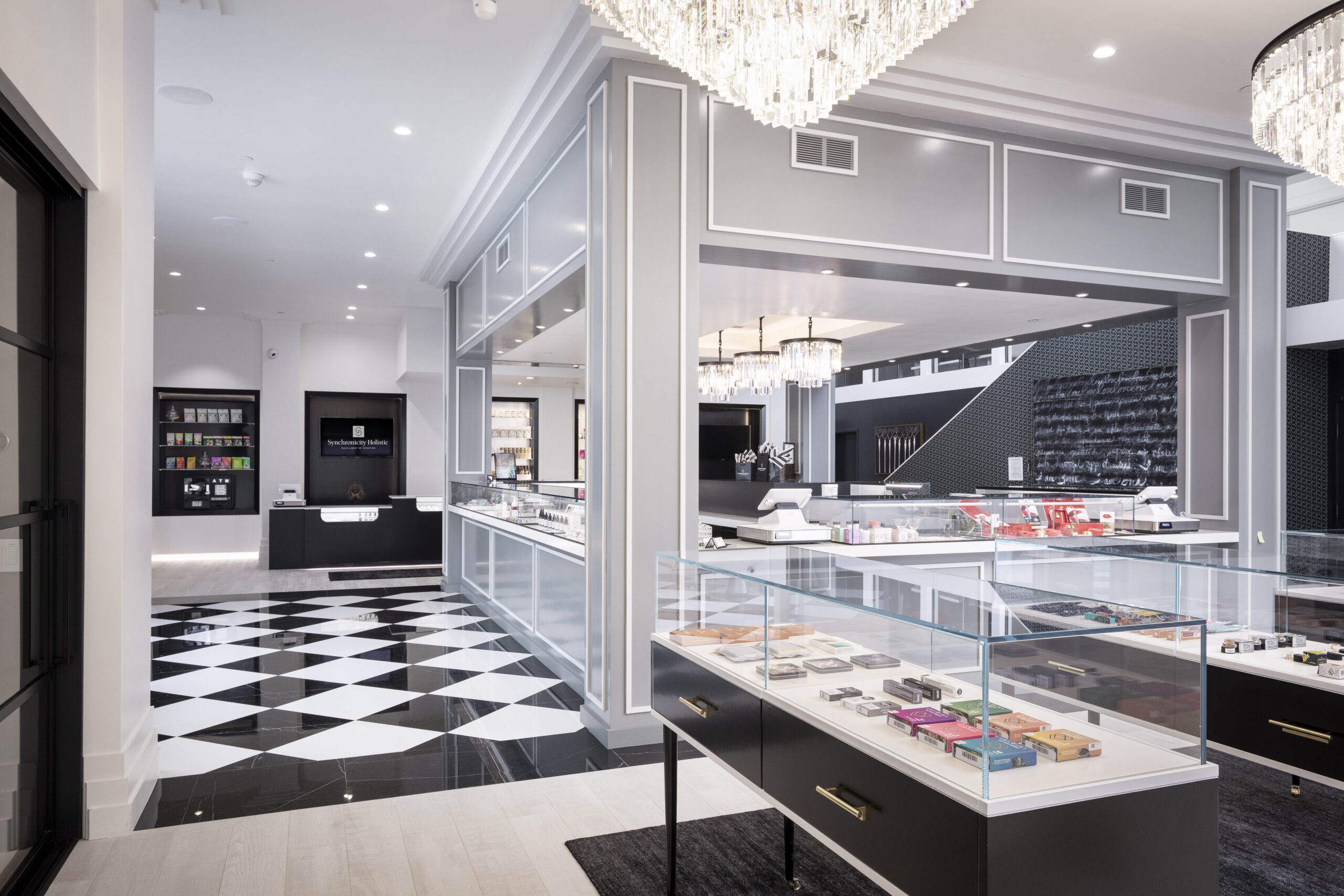 white room with black and white tiled floor and glass display cases